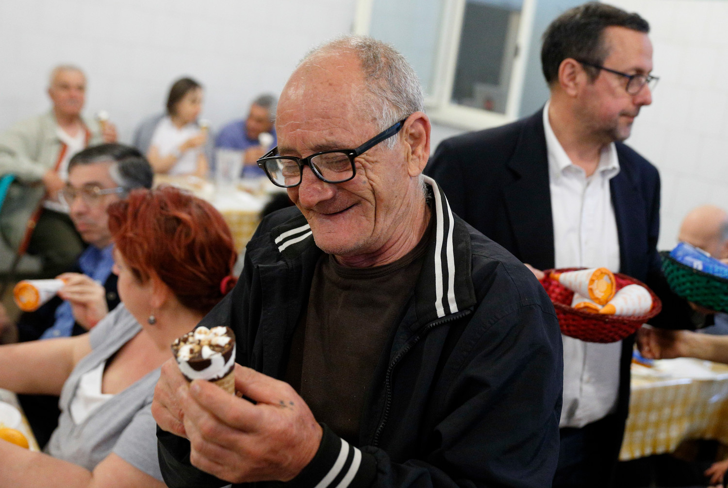 A man enjoys his ice cream cone donated by Pope Francis at a Sant’Egidio soup kitchen in Rome April 23. In honor of his name day, the feast of St. George, the Pope donated 3,000 servings of ice cream to soup kitchens and homeless shelters around Rome.